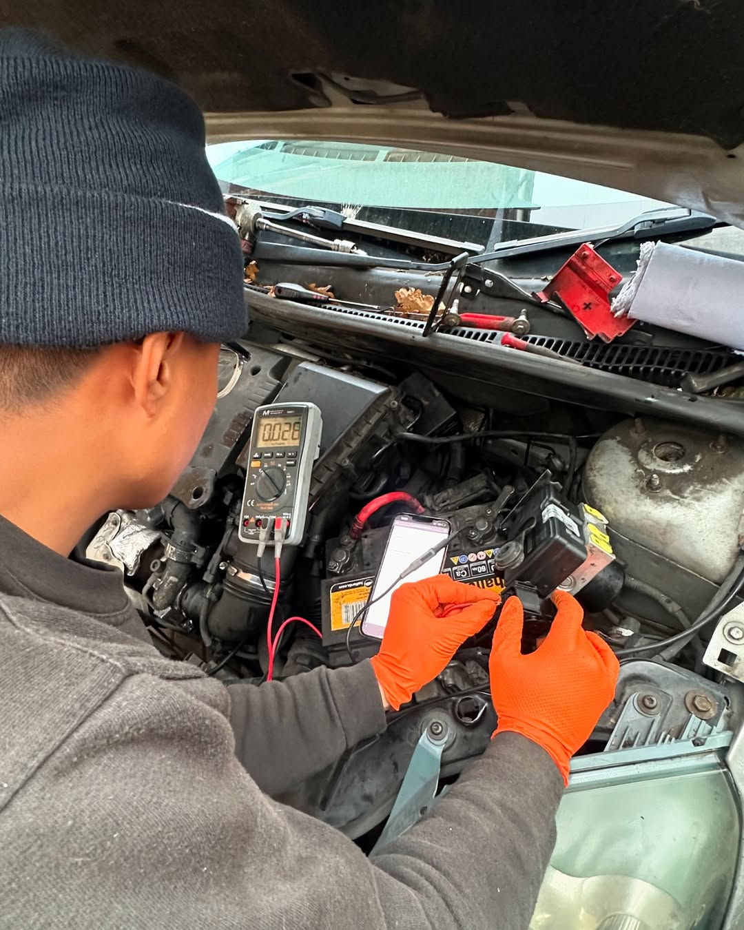 Lara AutoCentre technician testing an ABS electrical circuit with a multimeter