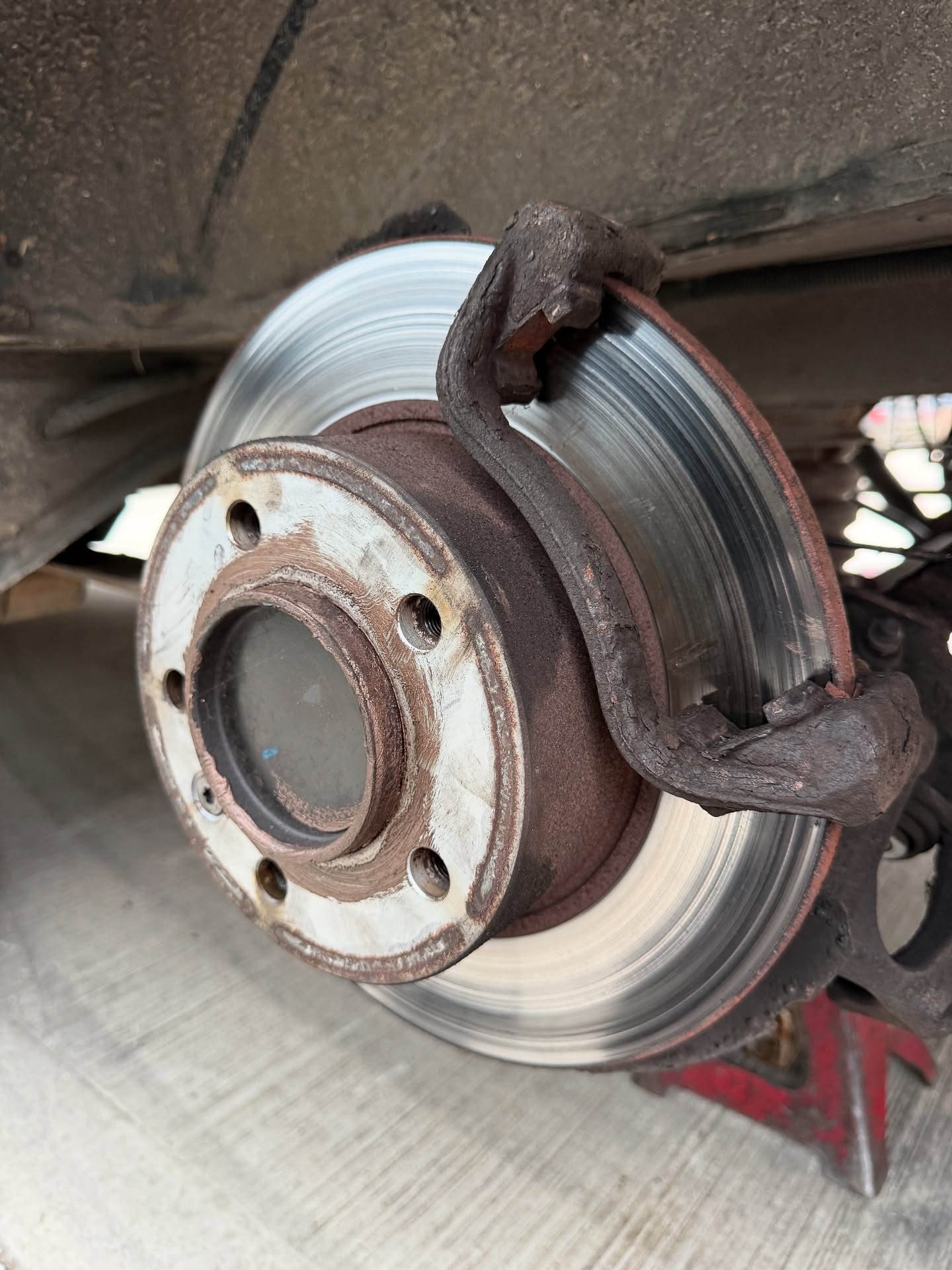 Rear brake disc and caliper bracket during our brake repair