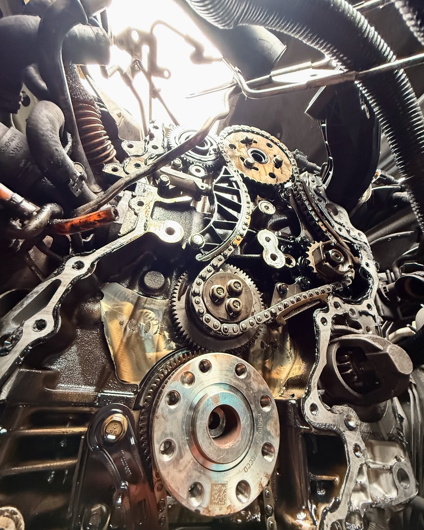 Engine opened for timing-chain repair with chains and sprockets exposed