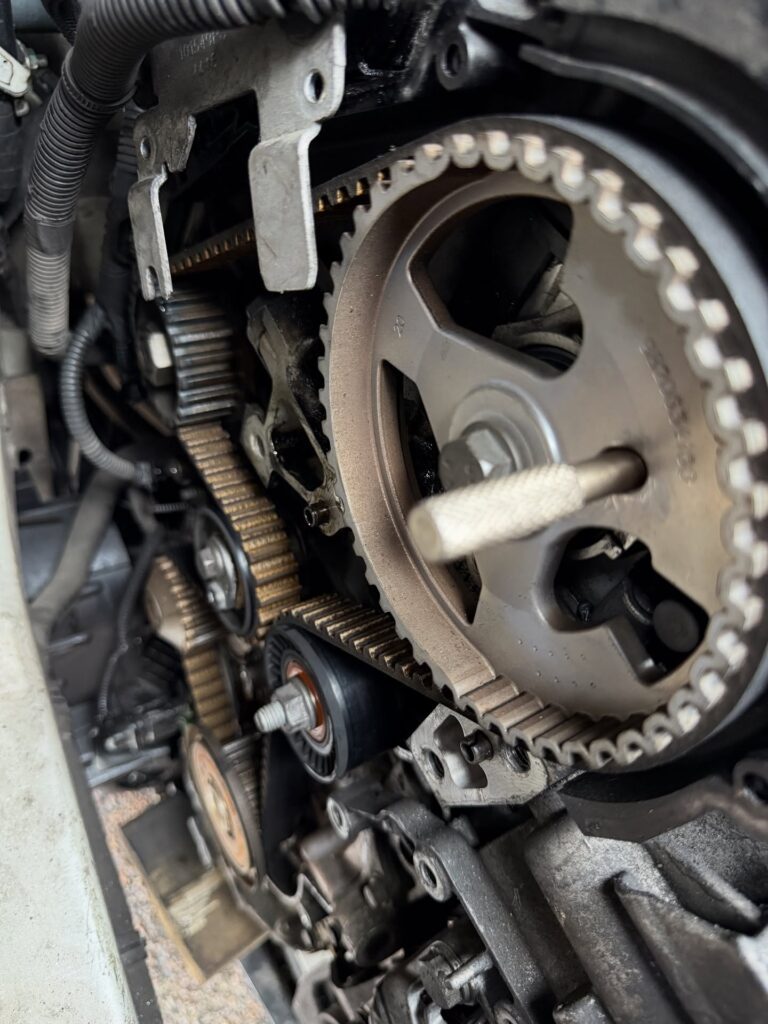 Genuine Lara AutoCentre timing belt and water pump replacement showing the exposed belt, pulley and tensioner.